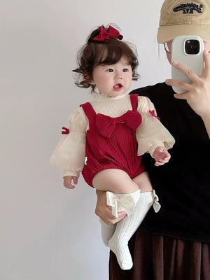Baby wearing the Red Riding Hood red romper with puff sleeves, bows and red beret