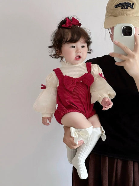 Baby wearing the Red Riding Hood red romper with puff sleeves, bows and red beret